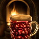 A mug of beer in front of an open fire.