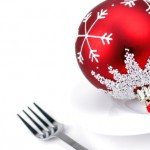 A fork next to a Christmas bauble on a plate.
