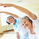 2 elderly women at an exercise class.