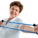 An elderly woman using a resistance band.