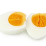 A cooked egg chopped in half.