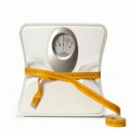A set of weighing scales wrapped in a tape measure.