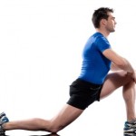 A man stretching his legs on a white background.