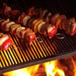 Kebabs being grilled on a barbecue.