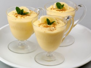 Three glasses of banana pudding on a white plate.