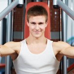 A man working out on a chest press machine.