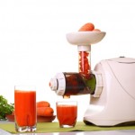 A white juicer with two glasses of juice.