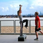 A personal trainer with a client training outside.